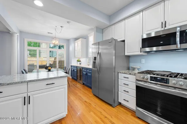 a kitchen with stainless steel appliances a stove a sink and a microwave
