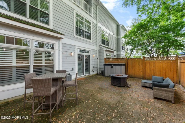 a backyard of a house with barbeque oven table and chairs