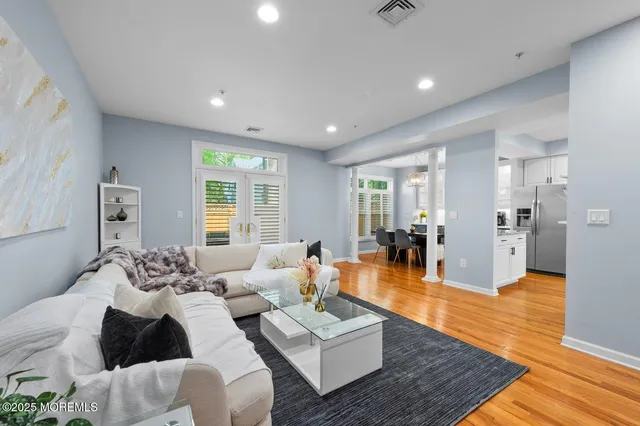 a living room with furniture and wooden floor