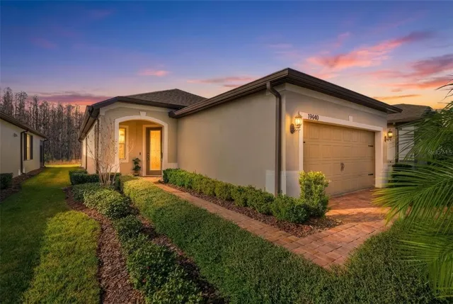 a front view of house along with garden and garage