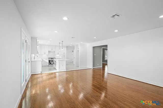 a bathroom with a double vanity sink a mirror and a shower