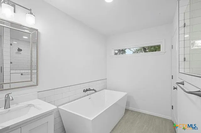 a view of a house with backyard and a tree