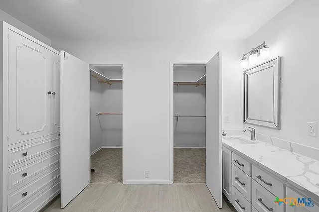 a view of a house with a small yard and a large tree