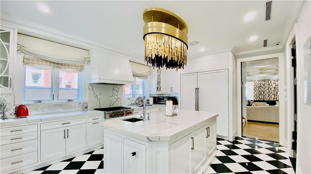222 Exeter Street Brooklyn, NY 11235 - Photo 11 of 39 a kitchen with a sink a stove and cabinets