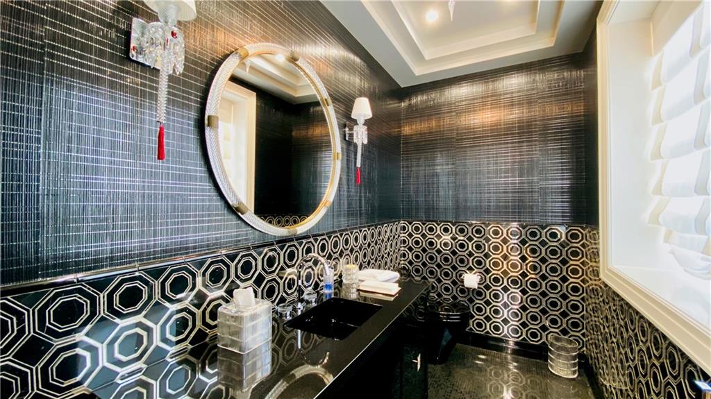222 Exeter Street Brooklyn, NY 11235 - Photo 13 of 39 a bathroom with a sink and a mirror