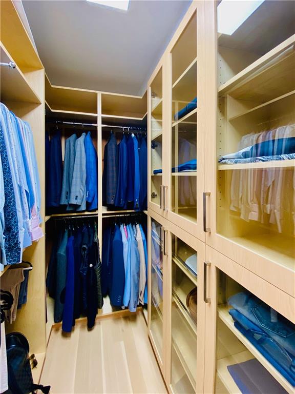 222 Exeter Street Brooklyn, NY 11235 - Photo 20 of 39 a view of walk in closet with clothes and shoes