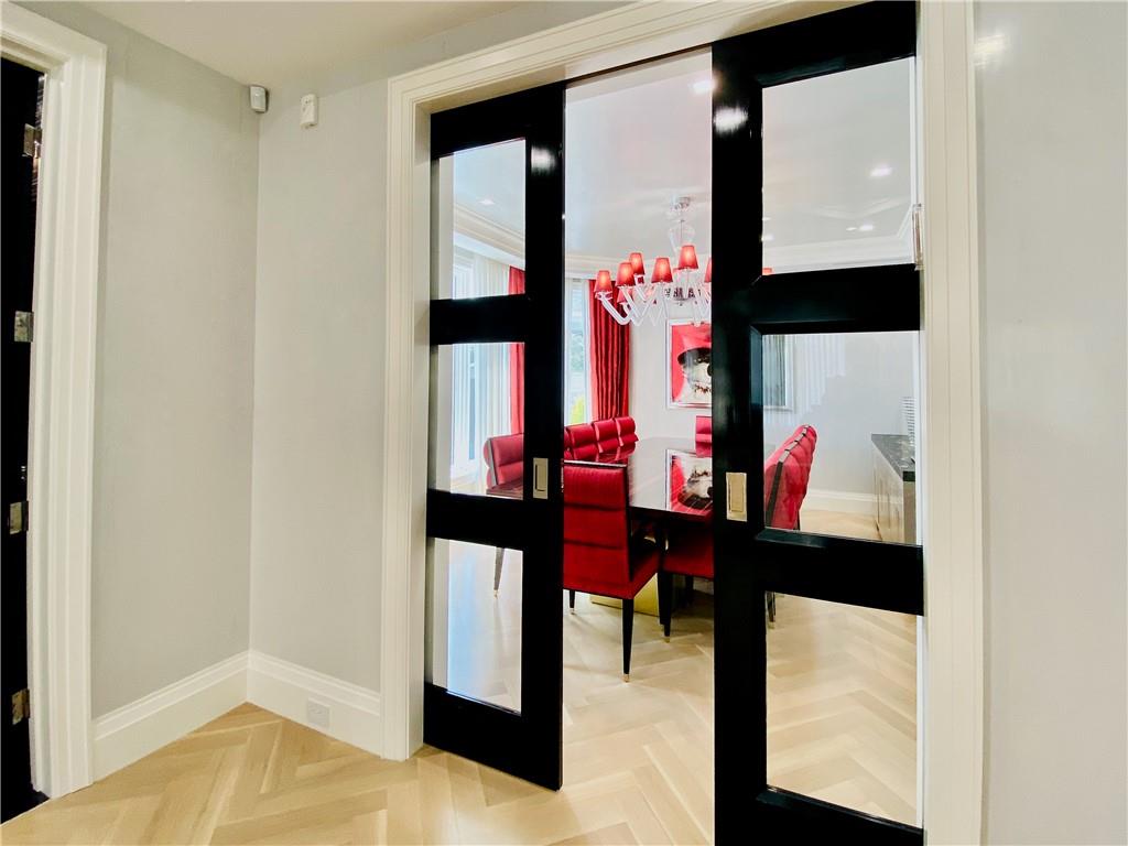 222 Exeter Street Brooklyn, NY 11235 - Photo 8 of 39 a view of a hallway with furniture and wooden floor