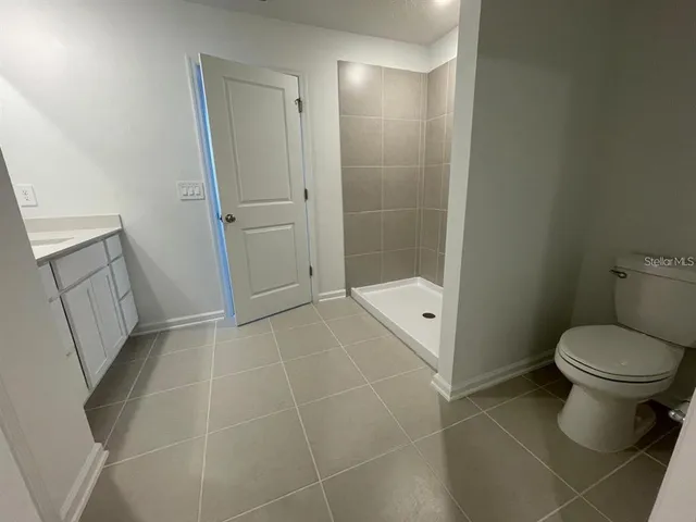 a bathroom with a toilet and a shower