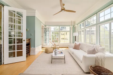 a dining room with wooden floor table and chairs