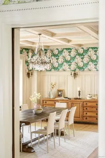 a kitchen with stainless steel appliances a table chairs and a refrigerator