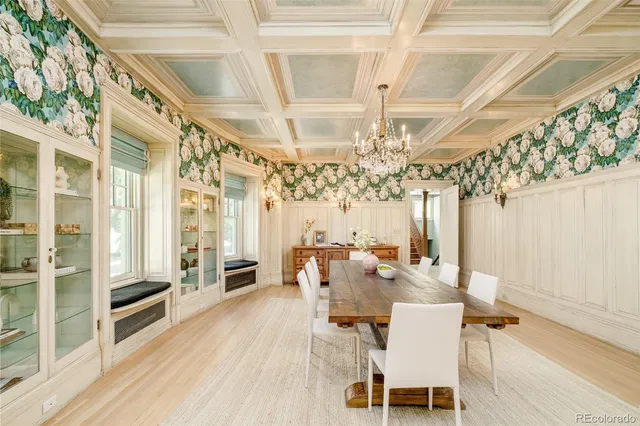 a kitchen with stainless steel appliances granite countertop a sink a window and chandelier