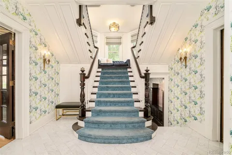 a living room with furniture and a chandelier