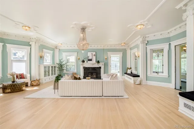 a living room with furniture a fireplace and a large window