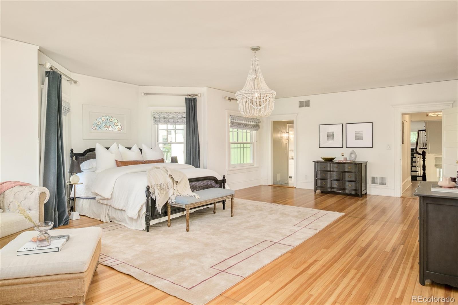 680 North Clarkson Street Denver, CO 80218 - Photo 24 of 39 a spacious bedroom with a bed and wooden floor