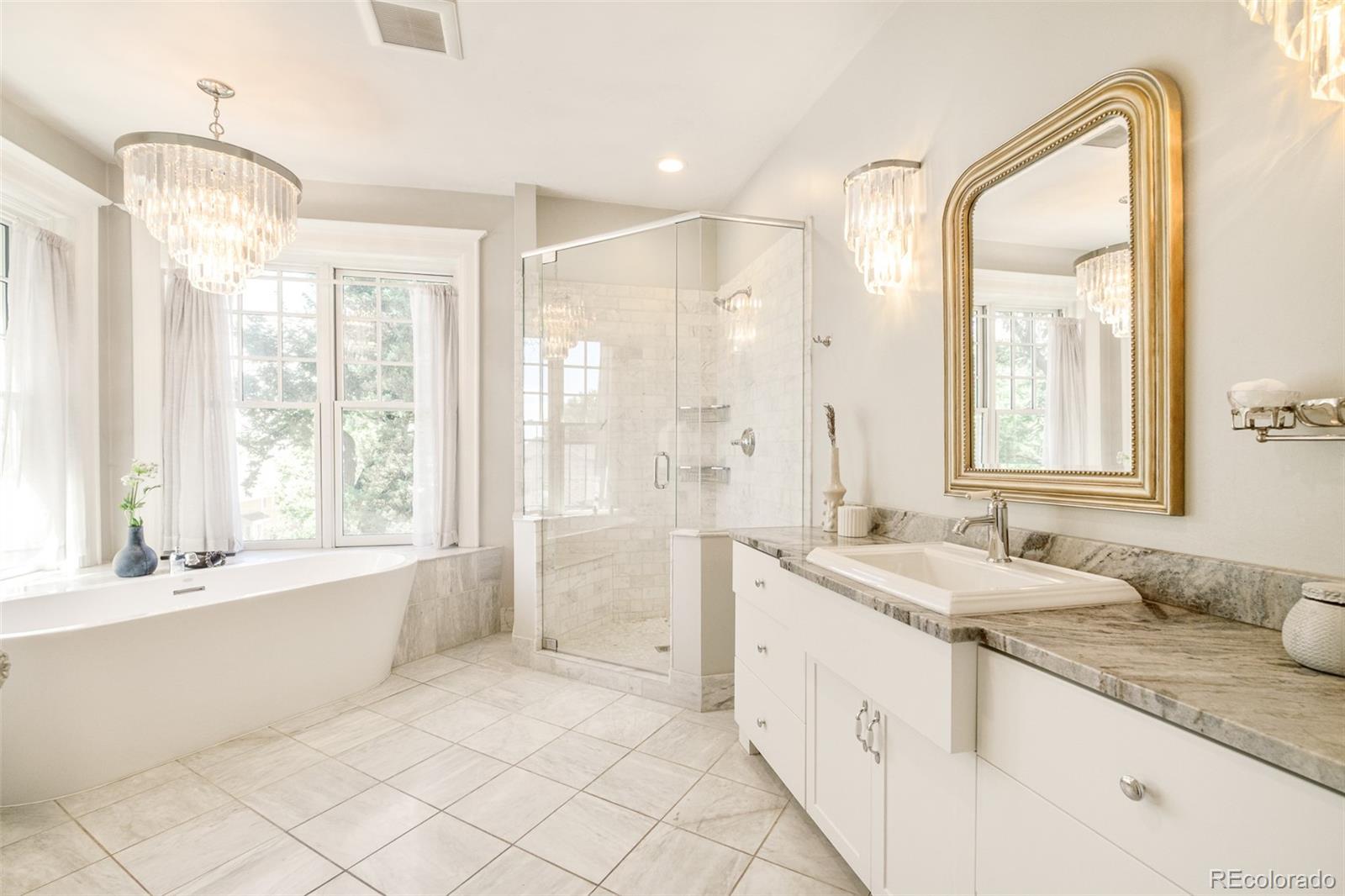 680 North Clarkson Street Denver, CO 80218 - Photo 25 of 39 a spacious bathroom with a double vanity sink mirror and a bath tub