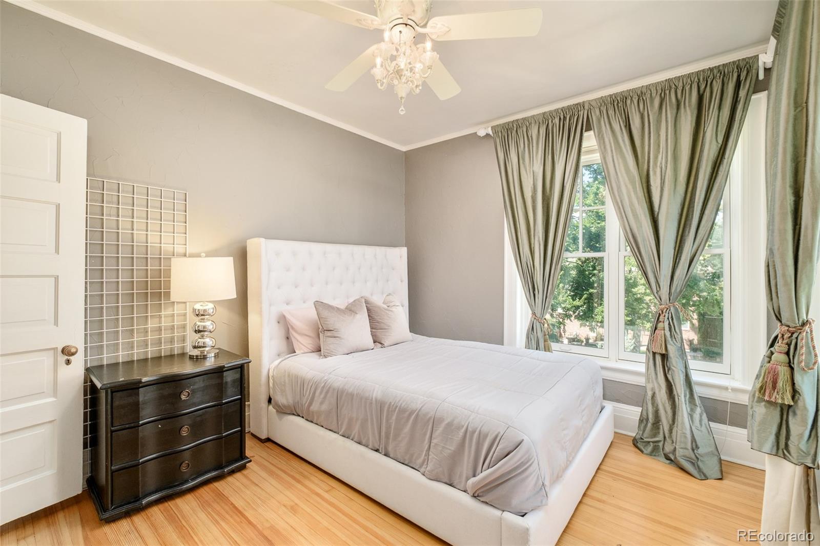 680 North Clarkson Street Denver, CO 80218 - Photo 27 of 39 a bedroom with a bed and a large window