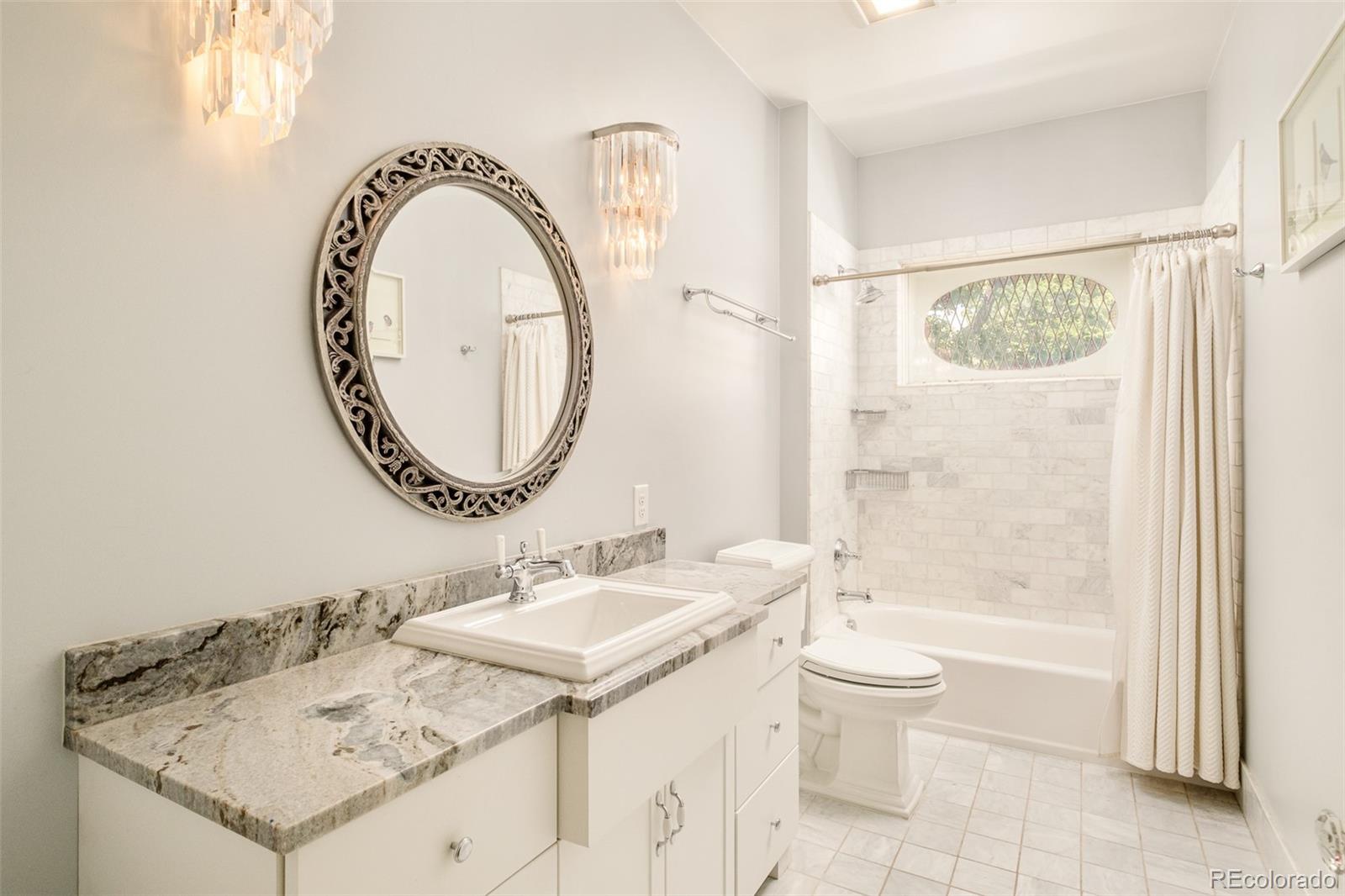 680 North Clarkson Street Denver, CO 80218 - Photo 28 of 39 a bathroom with a granite countertop sink a toilet and a mirror
