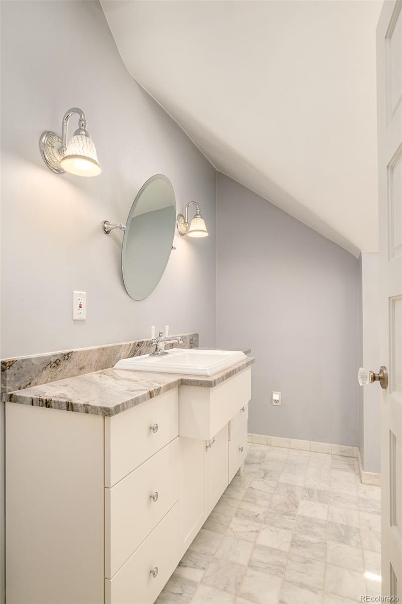 680 North Clarkson Street Denver, CO 80218 - Photo 32 of 39 a bathroom with a granite countertop sink a mirror and vanity