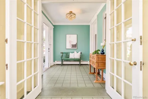 a view of a dining room with furniture and chandelier