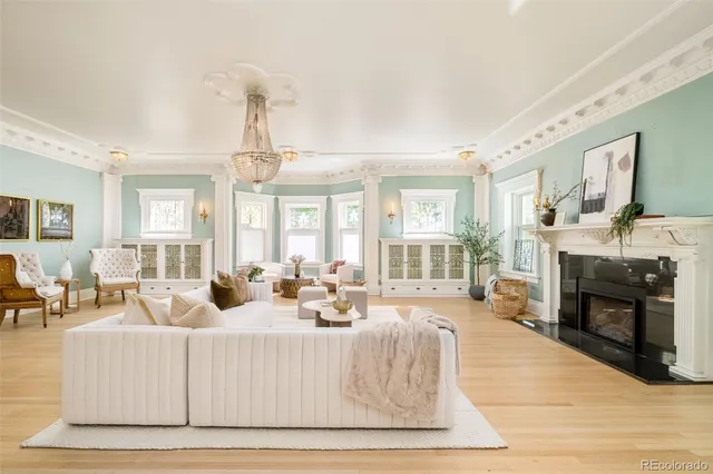 a living room with furniture and a chandelier