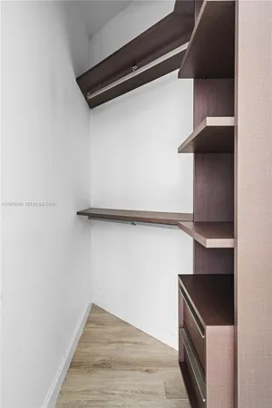 a living room with furniture and a dining table with kitchen view