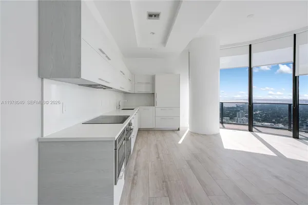 a view of a kitchen with a sink and dishwasher