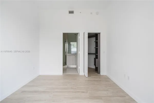a bathroom with a shower a sink and a mirror