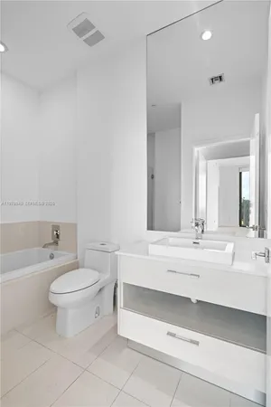 a bathroom with a shower and a bath tub