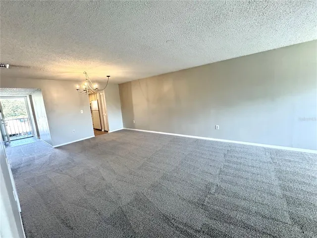 an empty room with a empty space and windows