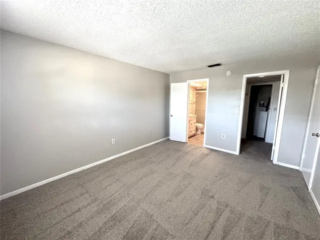 an empty room with closet and wooden floor