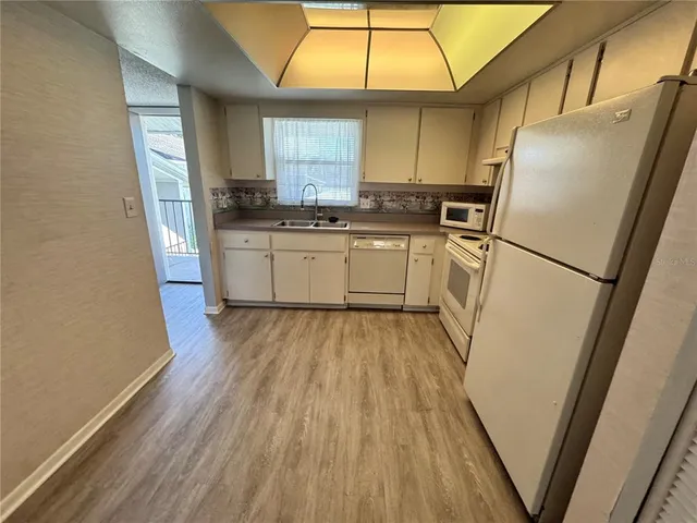 a kitchen with a refrigerator a sink and dishwasher