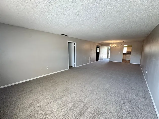 a view of a big room with closet and a large window