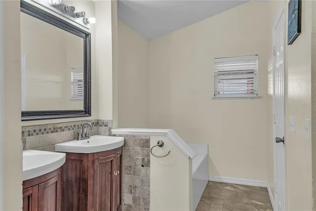 a bathroom with a sink and a mirror