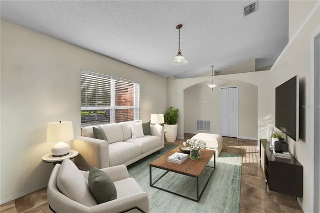 a living room with furniture and a flat screen tv