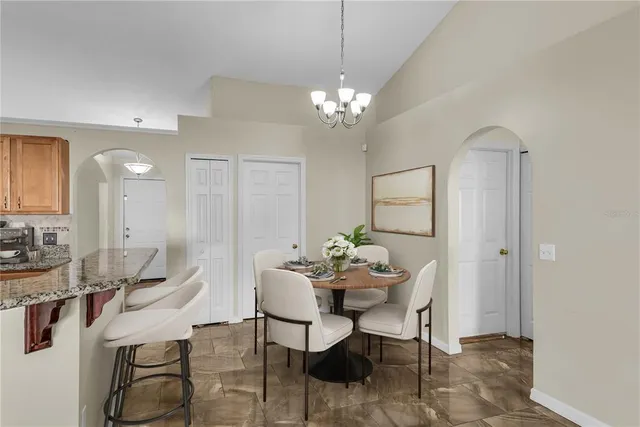 a view of a dining room with furniture and chandelier