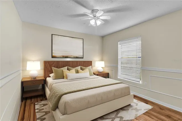 a bedroom with a large bed and a chandelier