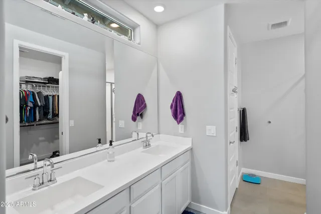 a bathroom with a sink vanity and mirror