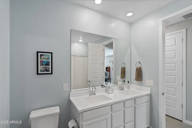 a living room with furniture a flat screen tv and a window