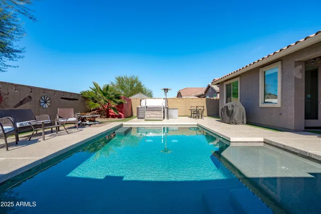 a view of a house with swimming pool and a yard