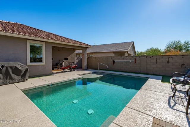 a view of backyard with seating area and barbeque oven