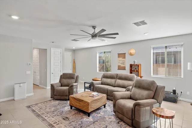 a living room with furniture a large window and a rug