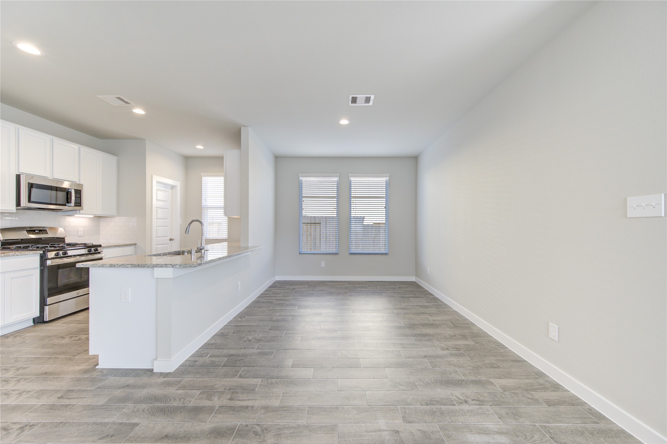 2623 Finley Lane Rosenberg, TX 77471 - Photo 11 of 49 a kitchen with stainless steel appliances granite countertop a stove top oven a sink dishwasher and a refrigerator with wooden floor