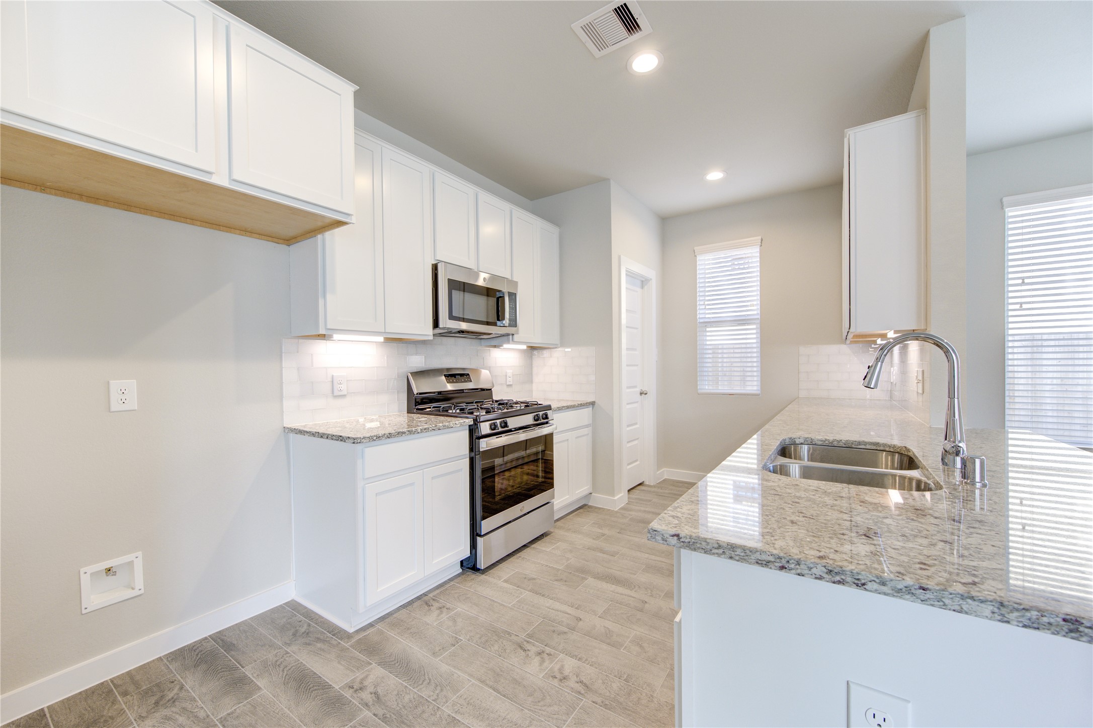 2623 Finley Lane Rosenberg, TX 77471 - Photo 15 of 49 a kitchen with granite countertop a sink stove and refrigerator