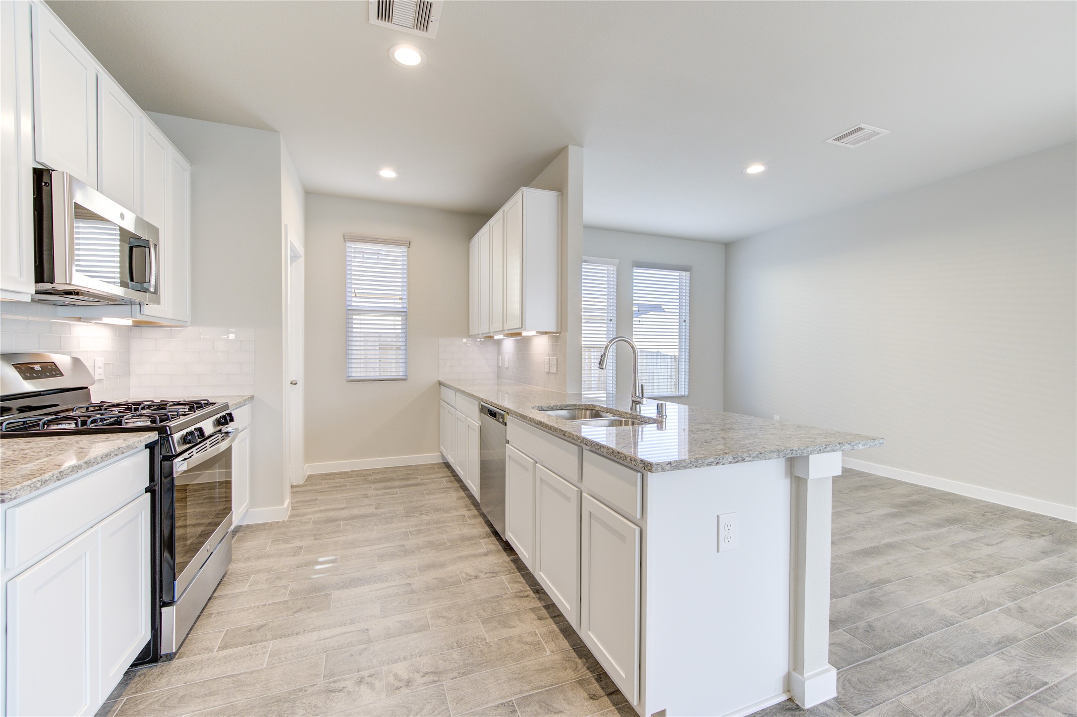 2623 Finley Lane Rosenberg, TX 77471 - Photo 17 of 49 a large kitchen with stainless steel appliances granite countertop a stove and a sink