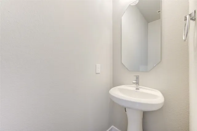 a bathroom with a sink and mirror