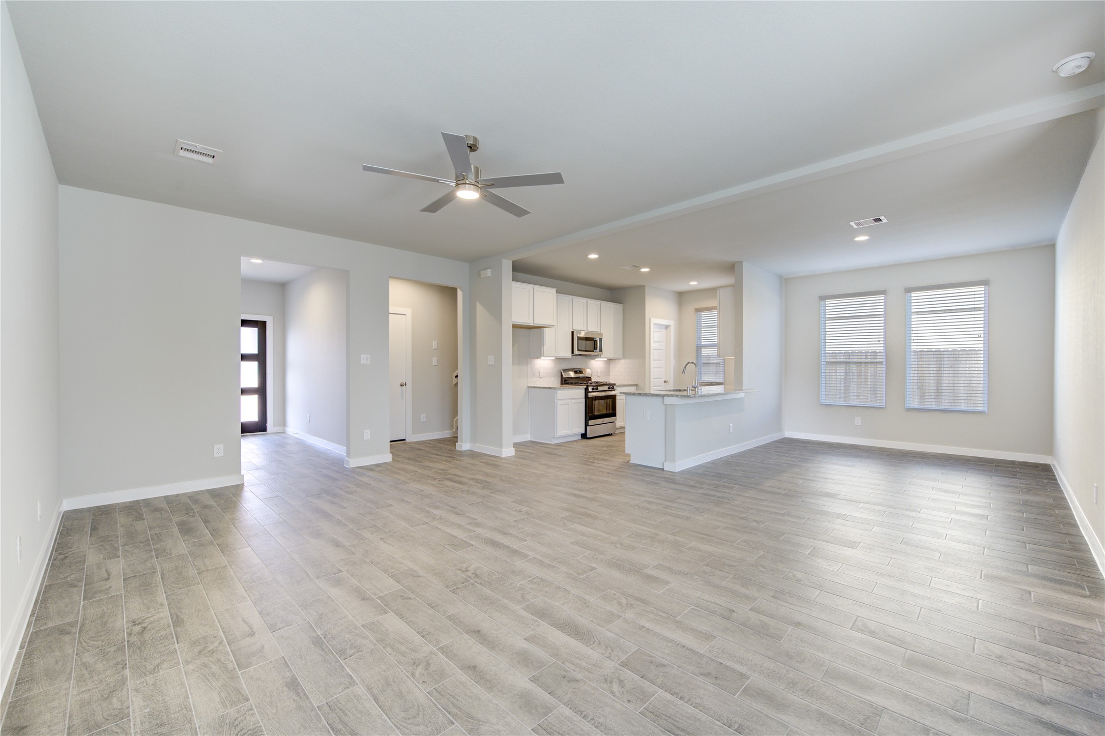 2623 Finley Lane Rosenberg, TX 77471 - Photo 8 of 49 a view of an empty room with wooden floor and a kitchen