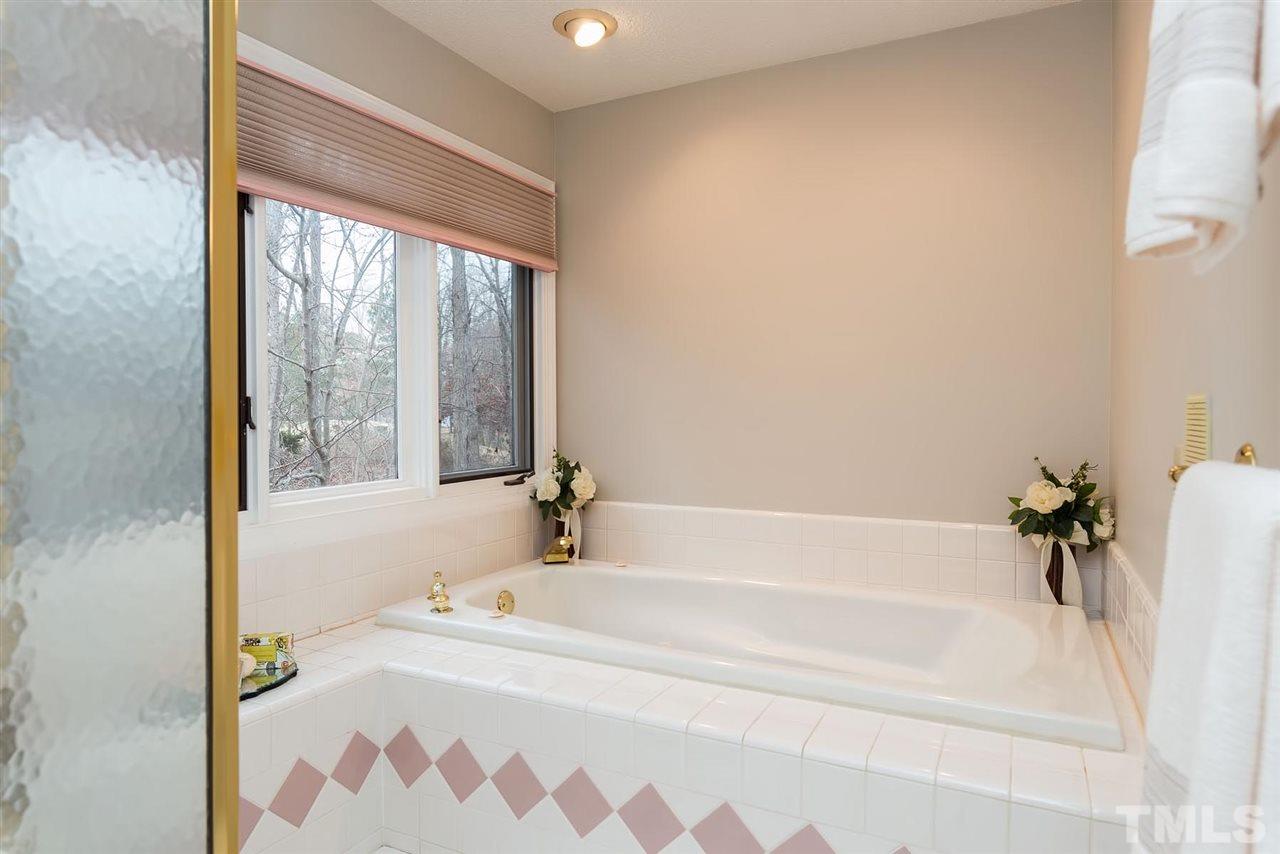 8816 Ross Court Raleigh, NC 27613 - Photo 14 of 25 a white bath tub sitting in a bathroom next to a window