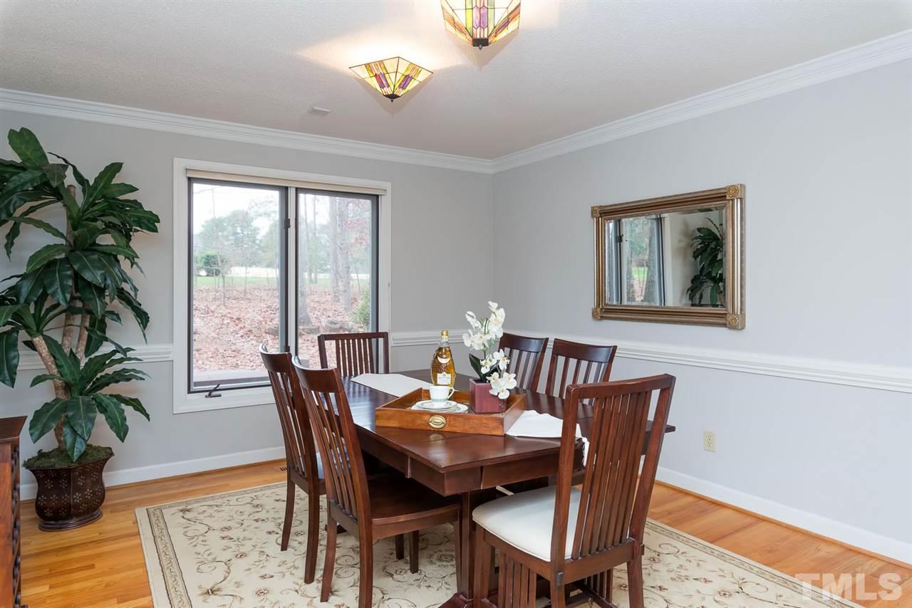 8816 Ross Court Raleigh, NC 27613 - Photo 8 of 25 a view of a dining room with furniture window and wooden floor