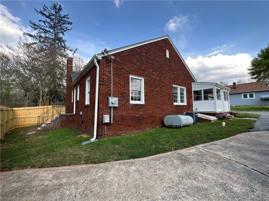Read view of the home showing the side entrance