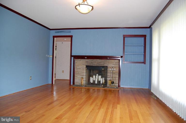 1207 Culvert Road Towson, MD 21286 - Photo 6 of 29 a view of an empty room with wooden floor and a fireplace